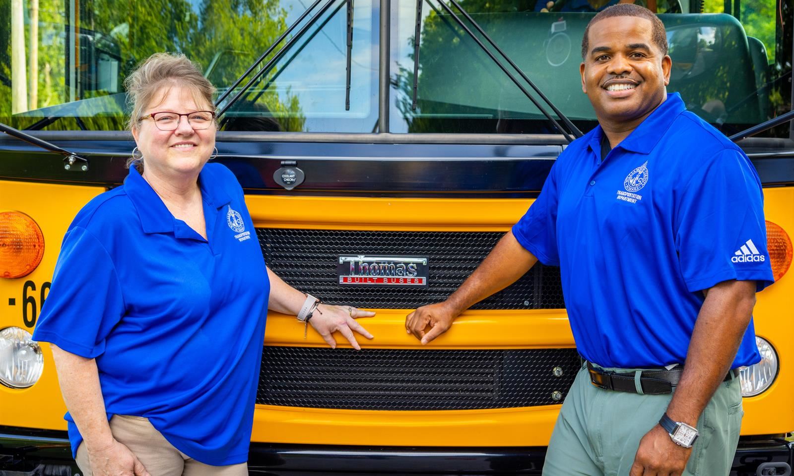 Two Bus drivers smile